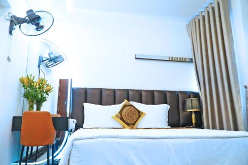a bedroom with a bed with a brown headboard at GRAD Queen Hotel 2 - Hà Đông in Hanoi