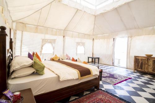a bedroom with a bed in a tent at Desert Signature Resorts in Sām