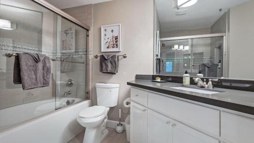 a bathroom with a toilet and a sink and a shower at Beautiful newly remodeled 2-Bdrm Biltmore Condo in Phoenix