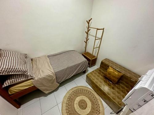 a bedroom with a bed and a chair and a stool at FLATFORM RENTALS (PAWN'S ROOM) in Cebu City