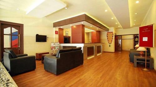 a large living room with couches and a television at The Hotel Palace Tower in Trichūr