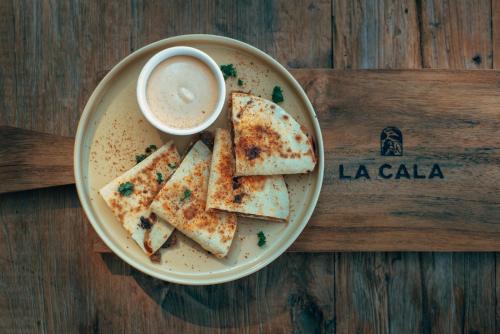 a plate of food with a cup of coffee and some bread at Gili Divers Hotel in Gili Trawangan