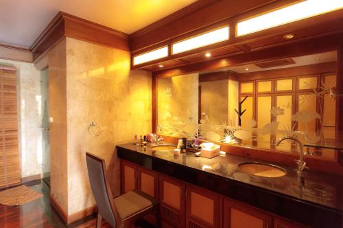 a bathroom with two sinks and a large mirror at Classic Thai style Cozy Villa pool garden in Patong Beach