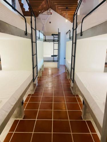 a row of bunk beds in a dorm room at Bappa's Place in Hiriketiya