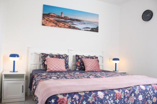 a bedroom with a bed with pink and blue sheets at Playa Troya In front of Beach, Very quiet in Playa de las Americas