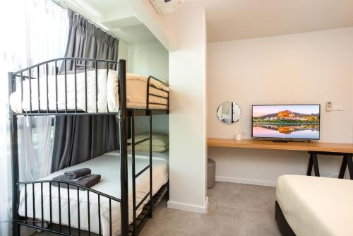 a room with two bunk beds and a desk at ISTY Design Hotel in Chiang Mai