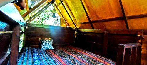 a small room with a pillow sitting on a rug at Uma Villa Manado in Manado