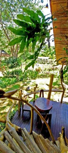 a wooden deck with a table and a chair at Uma Villa Manado in Manado