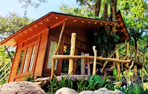 a cabin in a tree with lights on it at Uma Villa Manado in Manado
