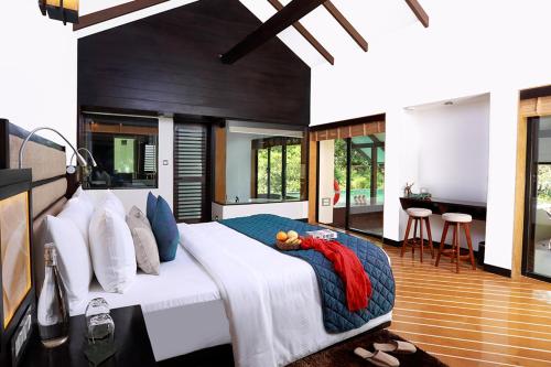 a bedroom with a large bed in a room at The IBNII - Eco Luxury Resort in Madikeri