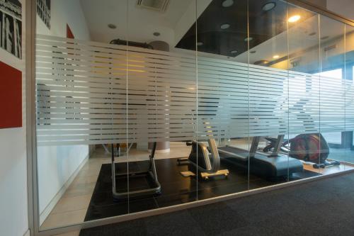 a gym with a window with blinds on it at Euro Hotel Residence in Concorezzo