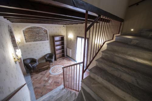 a room with a staircase with a chair and a window at Hotel Sesmones in Lodi