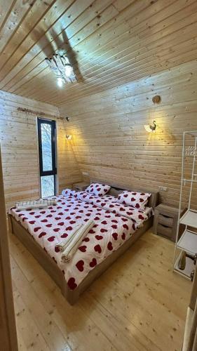 a bedroom with a bed in a wooden room at Dilijan Gold Resort in Dilijan