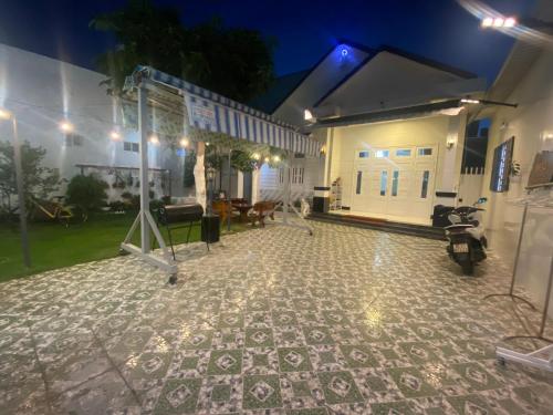 a building with a tiled floor in front of it at Villa sân vườn Misa in Phan Thiet