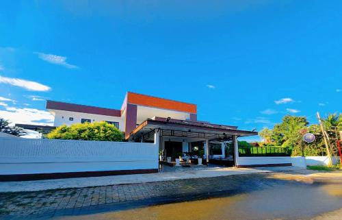 a building with a gas station next to a street at Cordelia Resort Sam Roi Yot in Sam Roi Yot