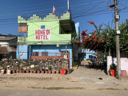 a building with a sign that reads home of motel at Hong Qi Hotel in Chitwan