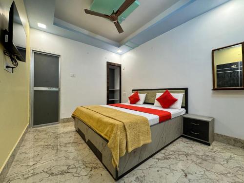 a bedroom with a large bed with red pillows at Hotel Nalanda City in Nalanda