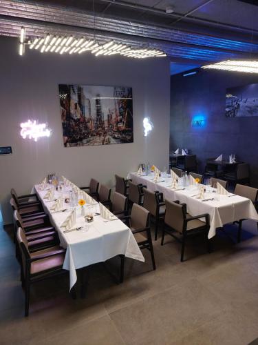 a dining room with white tables and chairs at SEA YOU in Klink