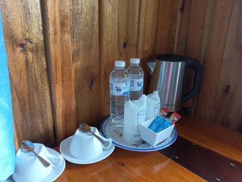 a table with two cups and two bottles of water at Kohjum Freedom Resort in Ko Jum