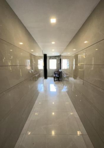 a hallway of a building with a table and chairs at Rs Regency Hotel in Mumbai