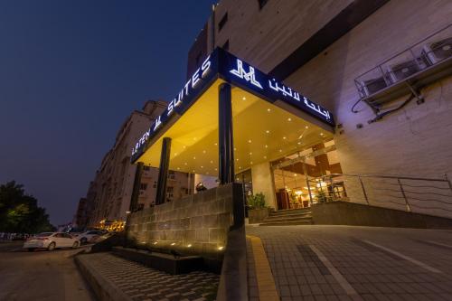 a building with a sign in front of it at Laten Suites Al Salim Plaza in Jeddah