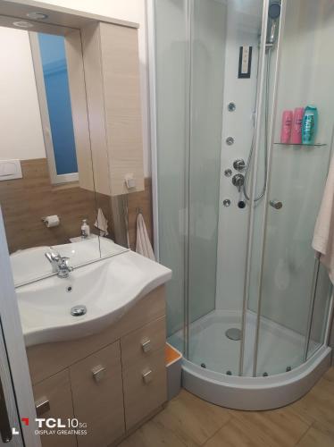 a bathroom with a sink and a shower at Villa ARA blu in Canegrate