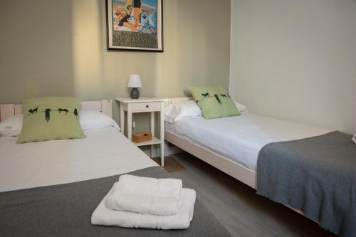 2 łóżka w małym pokoju z białą zasłoną w obiekcie Seneca7 near paseo de gracia w Barcelonie