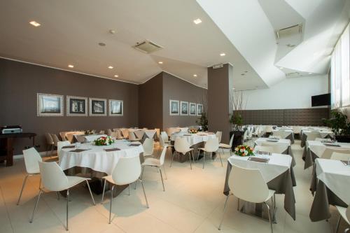 a dining room with white tables and chairs at Euro Hotel Residence in Concorezzo