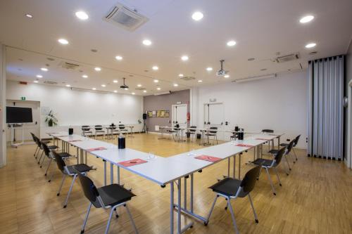 a conference room with a long table and chairs at Euro Hotel Residence in Concorezzo