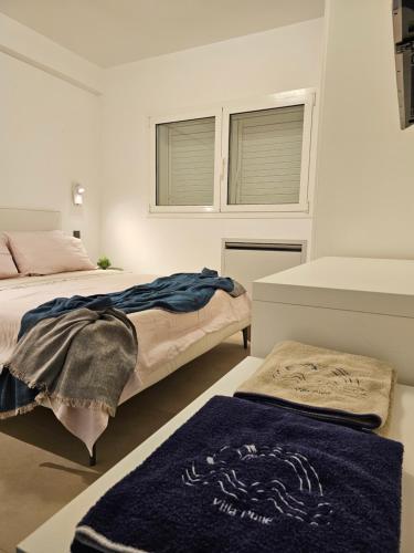 a bedroom with two beds and two windows at Villa Dune Luxury Roof Top Pool Wellness in Gallipoli