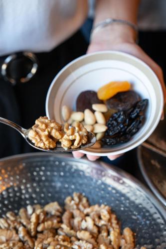a person holding up two spoons with food on them at Key Hotel in Izmir