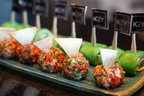 a bunch of food on a tray with wooden sticks at Key Hotel in Izmir