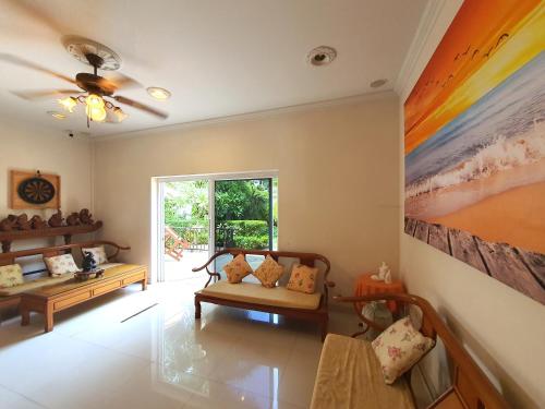 a living room with a couch and a painting on the wall at Serene Sands in Bang Lamung