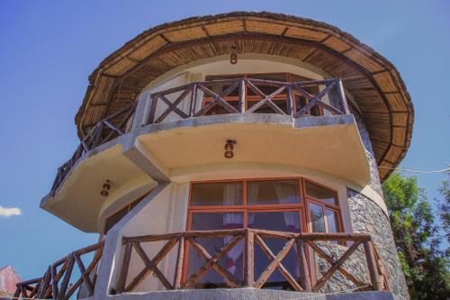 a building with a window and a blue sky at Lalibela Hidmo Cozy Place in Lalībela