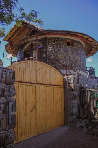 a wooden gate in front of a stone building at Lalibela Hidmo Cozy Place in Lalībela