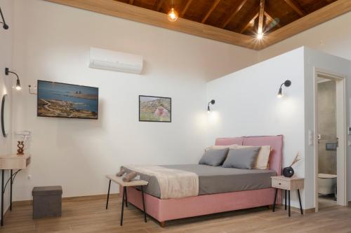 a bedroom with a bed in a white wall at Apolithon Premium Houses in Sígrion