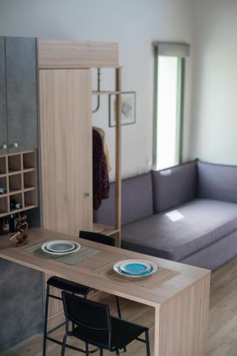 a living room with a table and a couch at Apolithon Premium Houses in Sígrion