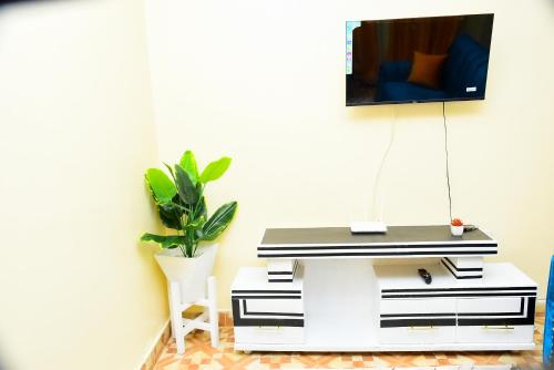a tv sitting on top of a white entertainment center at Royalty Homes in Nairobi
