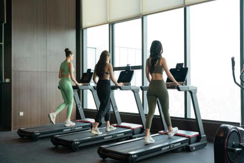 three women on a treadmill in a gym at Grand K Hotel Suites Hanoi in Hanoi