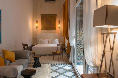 a living room with a bed and a couch at Riad Palais Bahia Fes in Fez