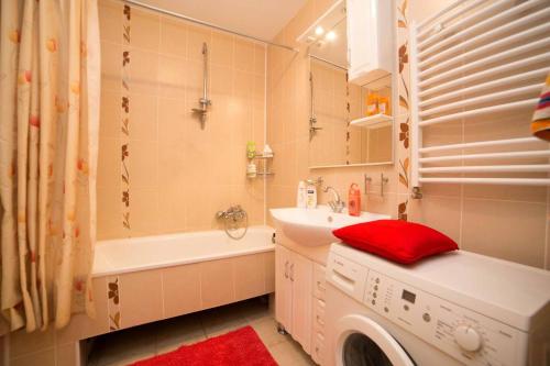 a bathroom with a sink and a washing machine at новобуд 2 кімнати Вернадського 8 in Lviv