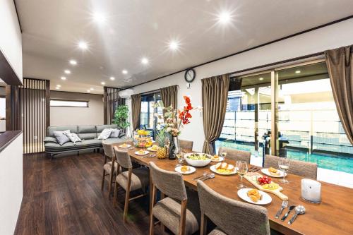 a dining room with a long table and chairs at PEACE OF REST TAKASHIMA in Takashima