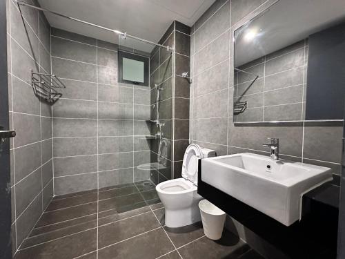 a bathroom with a white sink and a toilet at Hygge Living@Sunway Onsen in Tambun