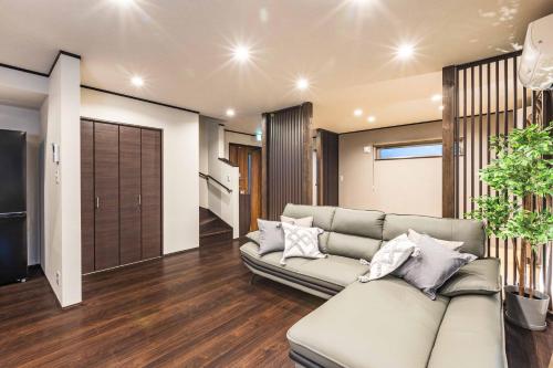 a living room with a couch and a sliding door at PEACE OF REST TAKASHIMA in Takashima