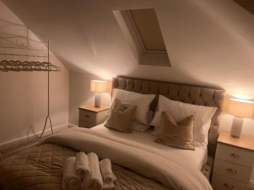 a bedroom with a large bed with two lamps at Abingdon in Sunningwell