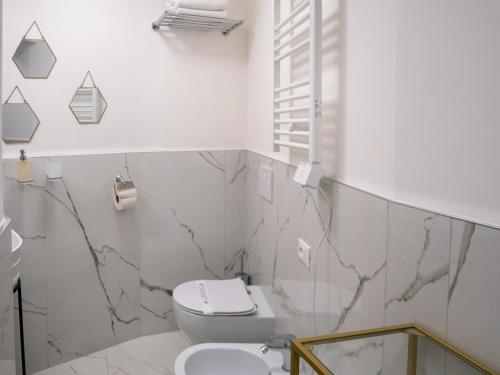 a bathroom with a toilet and a sink at Alto Apartment in Rome