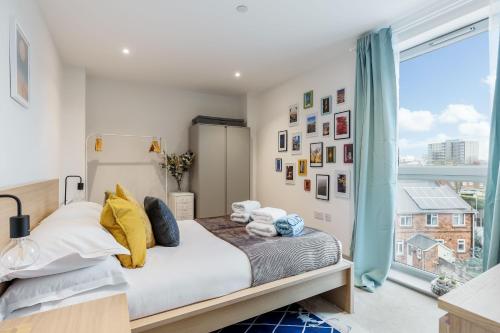 a bedroom with a bed and a large window at Little Gem in Poole
