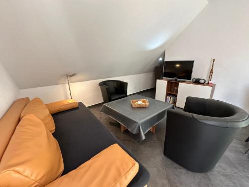 a living room with a couch and a table at Gocher Berghof Ferienwohnungen Langanke in Goch
