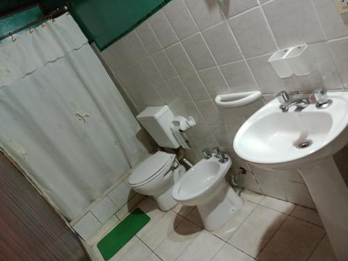 a bathroom with a toilet and a sink and a shower at Cabaña hospedaje mis nietas AJB in Las Compuertas