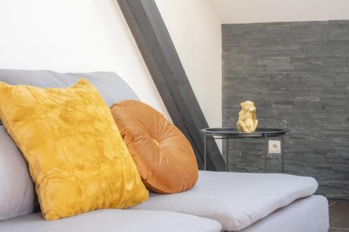 a yellow pillow sitting on a table next to a couch at Nouveau - Le Funtastic - Europa Park Rulantica in Huttenheim
